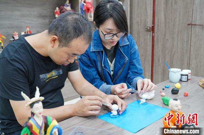 <a target='_blank'  data-cke-saved- >中新社</a>記者(右)現(xiàn)場體驗(yàn)面塑制作過程?！￡悹帍?qiáng) 攝