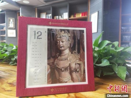 圖為徐晉林制作的敦煌題材的手工書(shū)《走進(jìn)沙漠敦煌——莫高窟與藏書(shū)票藝術(shù)》，深受讀者喜愛(ài)。　閆姣 攝