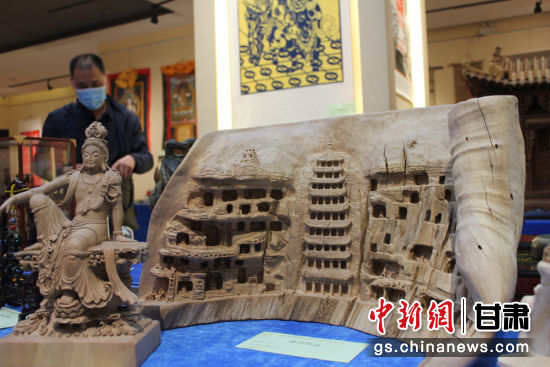 連日來，甘肅省工藝美術(shù)行業(yè)評審認定工作會議在蘭州舉行。圖為以敦煌莫高窟為題材的木雕作品《守護》。徐雪 攝